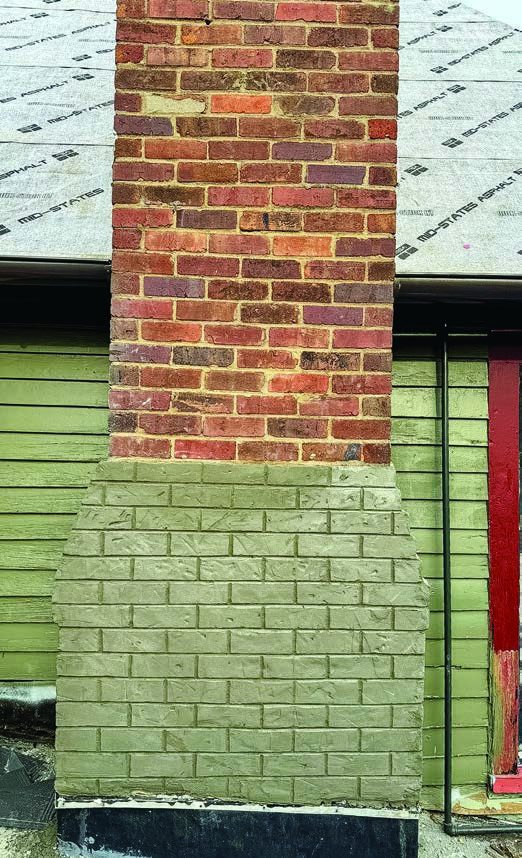 Chimney and siding, mid-restoration.