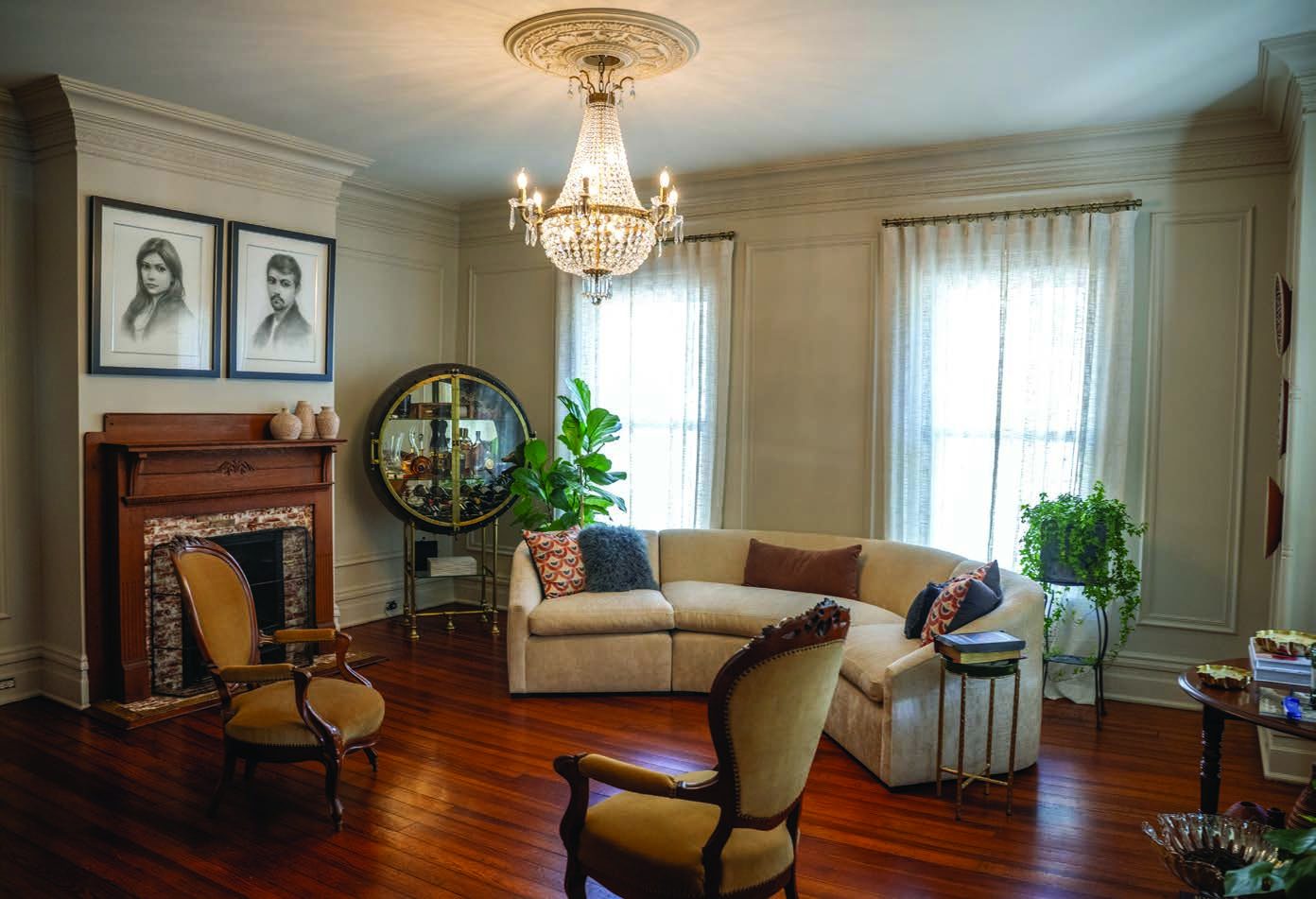 The restored front parlor with original fireplace and oak floors
