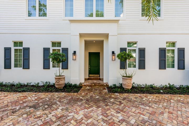 Classic white facade with a herringbone brick entry, Coral Gables Residence 2