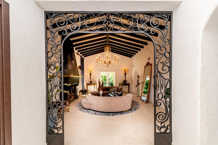 Wrought-iron archway into a living room, Miami Gardens Residence